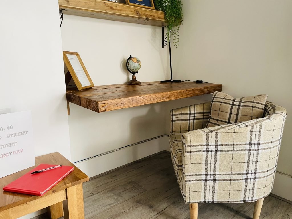 Desk and armchair in the living area at King Street Holiday Apartment, Inverness
