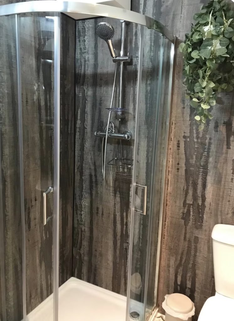 Bathroom shower enclosure and toilet at King Street Holiday Apartment, Inverness
