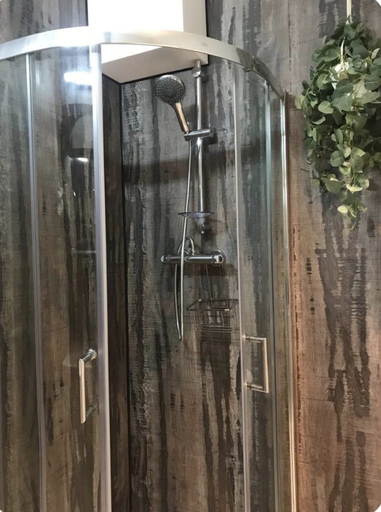 Shower enclosure and hanging greenery at King Street Holiday Apartment, Inverness